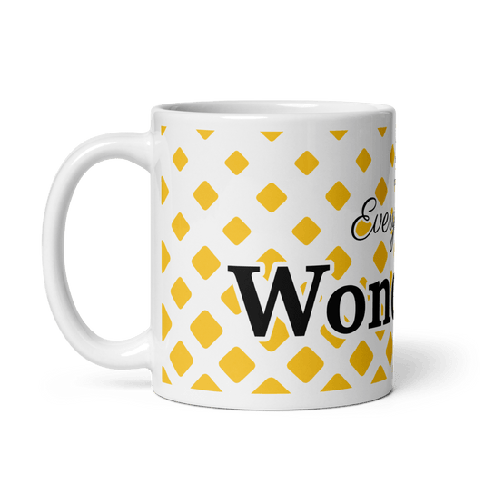 A white ceramic mug with yellow geometric shapes and the text 'EVERY DAY IS WONDERFUL' printed on it.