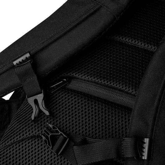 Close-up of a black backpack with mesh padding and zippers.