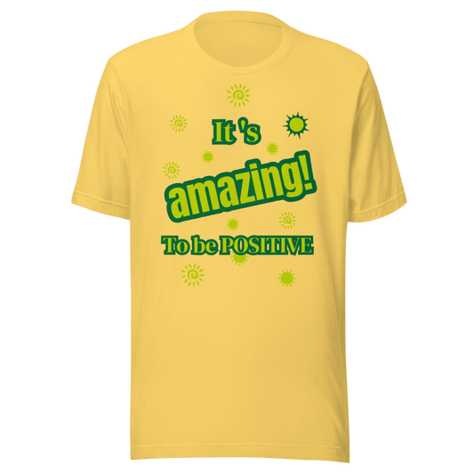 A yellow t-shirt with the text 'It's Amazing to be POSITIVE' and small green dots and a sun-like symbol on the front.