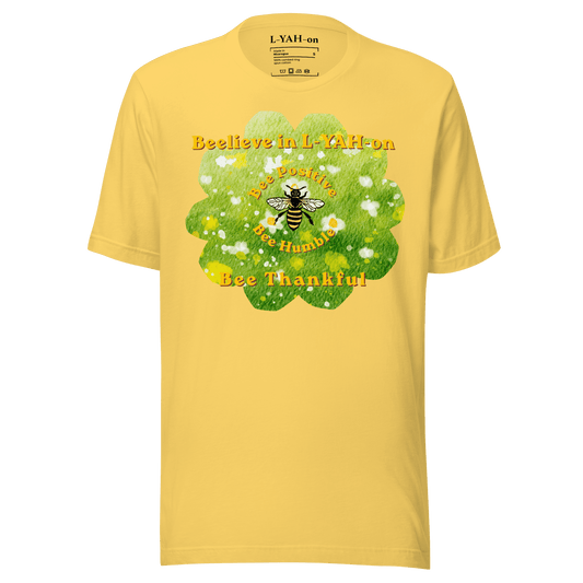 Yellow t-shirt with a bee and floral design on a green background