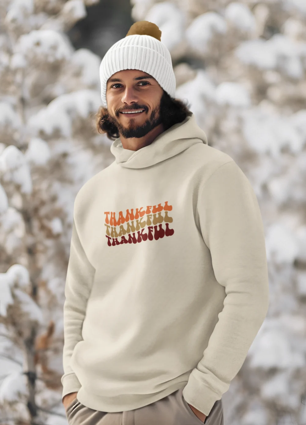 a bearded man wearing a L-AH-on hoodie in a snowy natural landscape