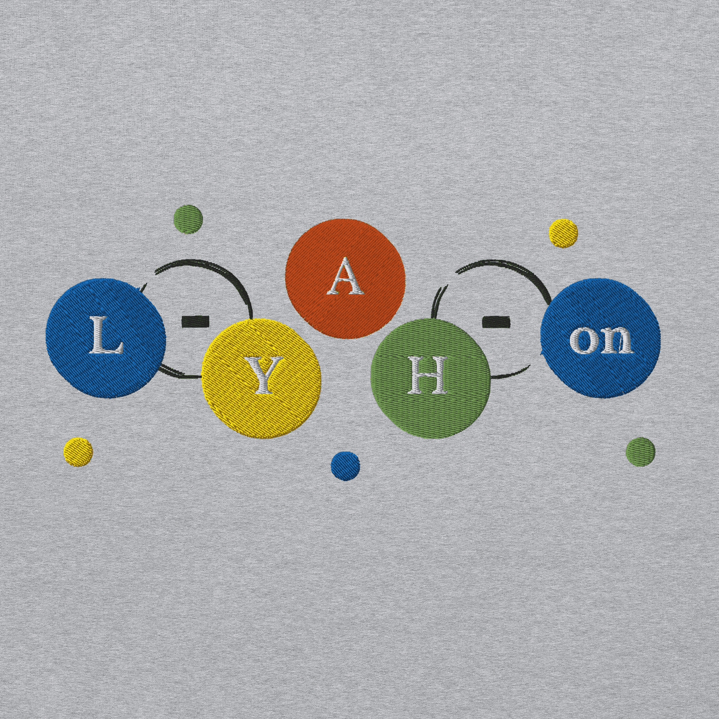 Embroidered text with colorful letters on a gray fabric background