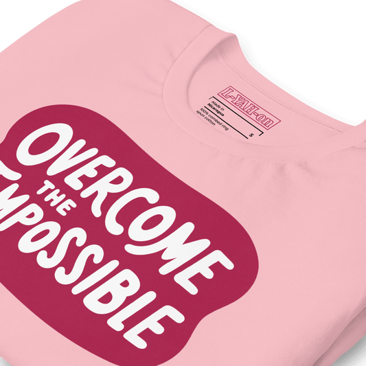 A pink t-shirt with the text 'OVERCOME THE IMPOSSIBLE' printed in pink and white color.