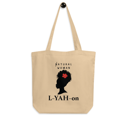 A beige organic cotton tote bag with a graphic print of a woman's silhouette and the brand name 'L-YAH-on'.