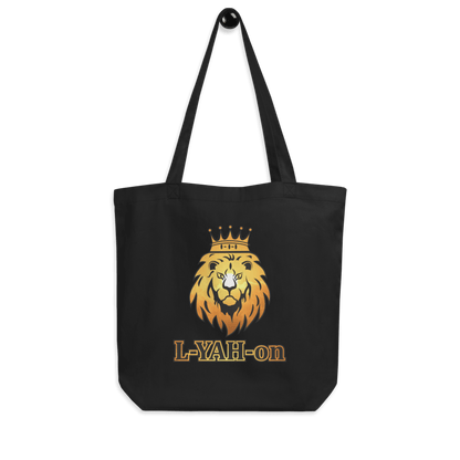 A black organic cotton tote bag with a graphic print of a lion's head wearing a crown and the brand name 'L-YAH-on' on the front.