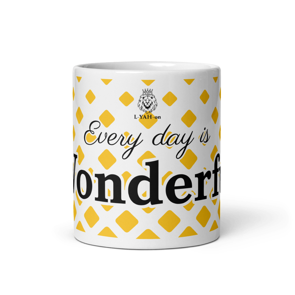 A white ceramic mug with yellow geometric shapes and the text 'EVERY DAY IS WONDERFUL' printed on it.