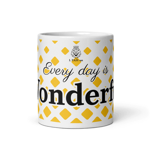 A white ceramic mug with yellow geometric shapes and the text 'EVERY DAY IS WONDERFUL' printed on it.